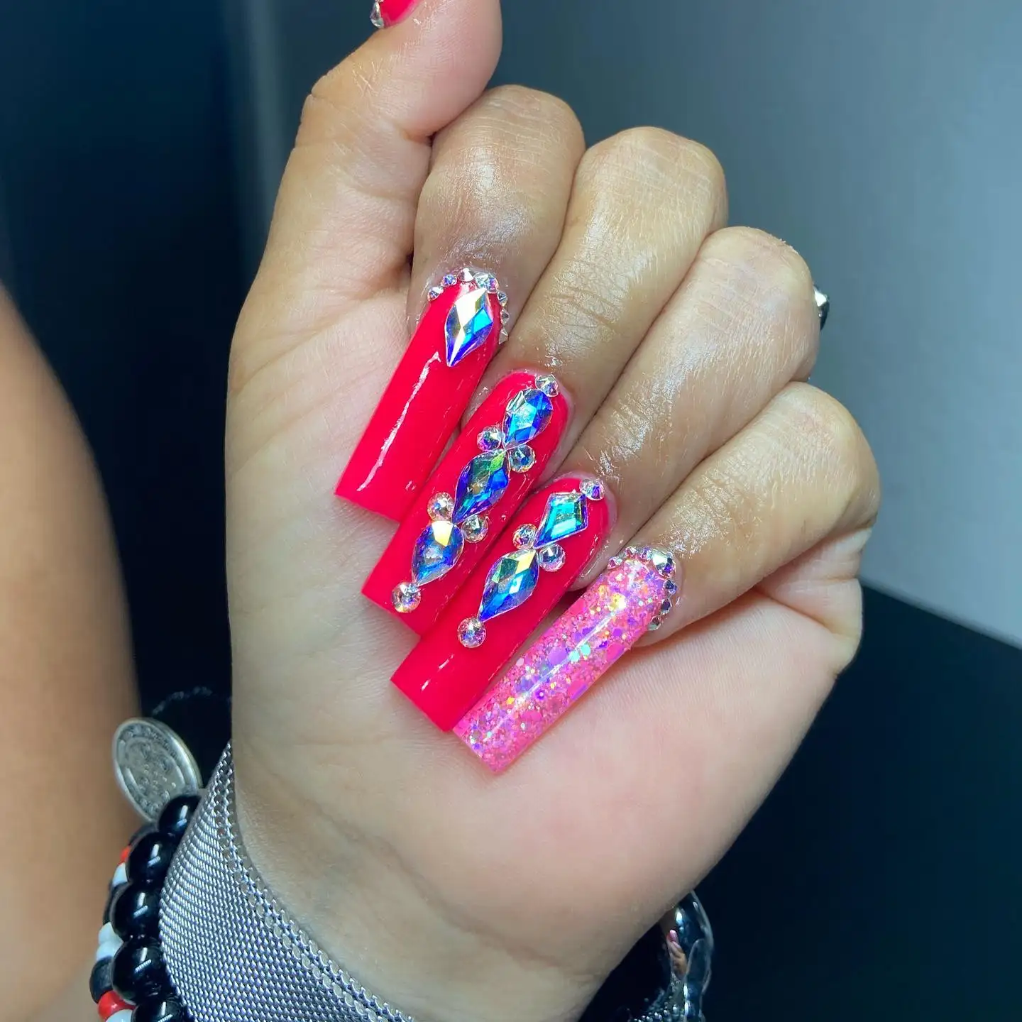 Short almond-shaped nails in glossy white with a single black beetle design on the ring finger.