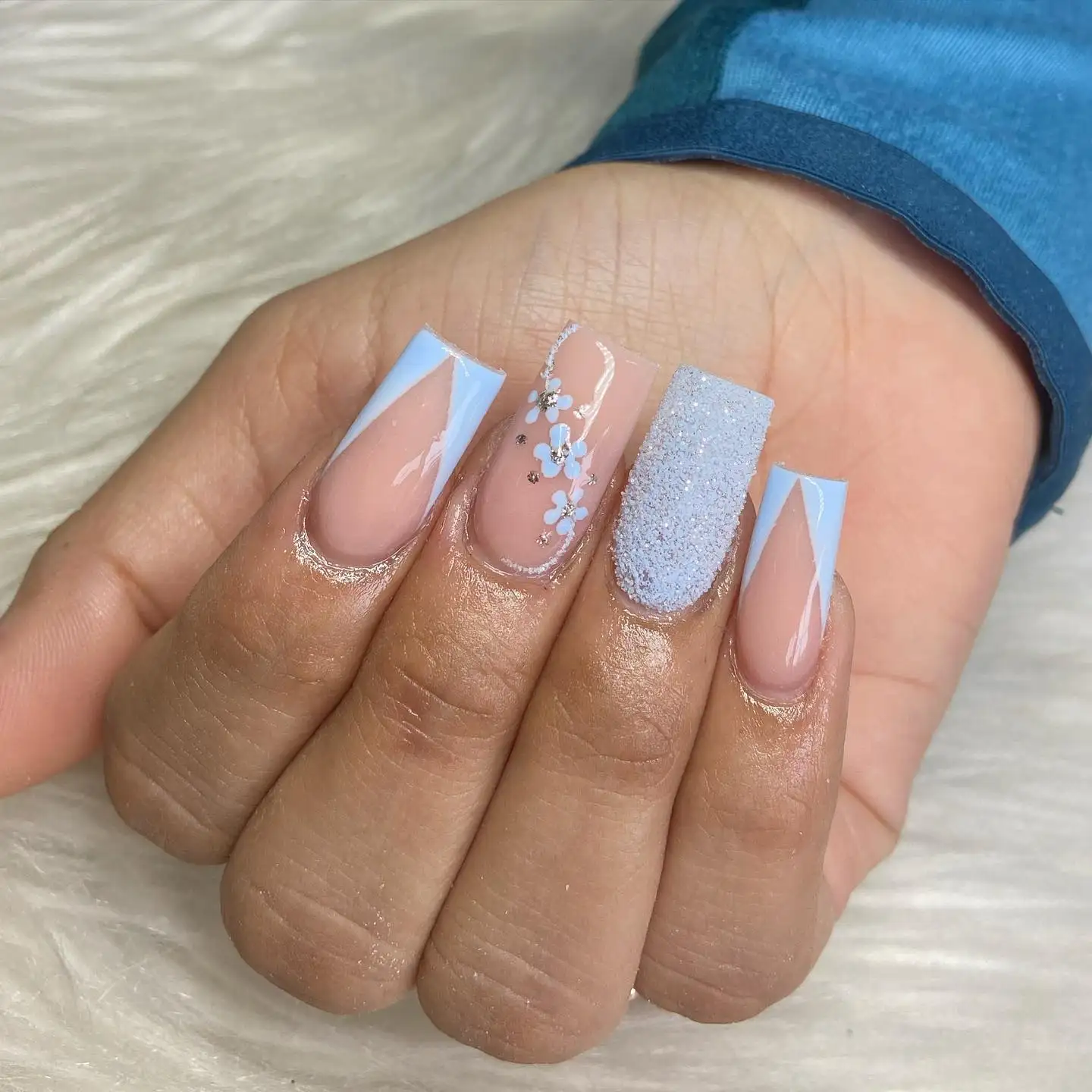 Short almond nails with a soft nude base and fine diagonal white stripes for a clean wrapped effect.
