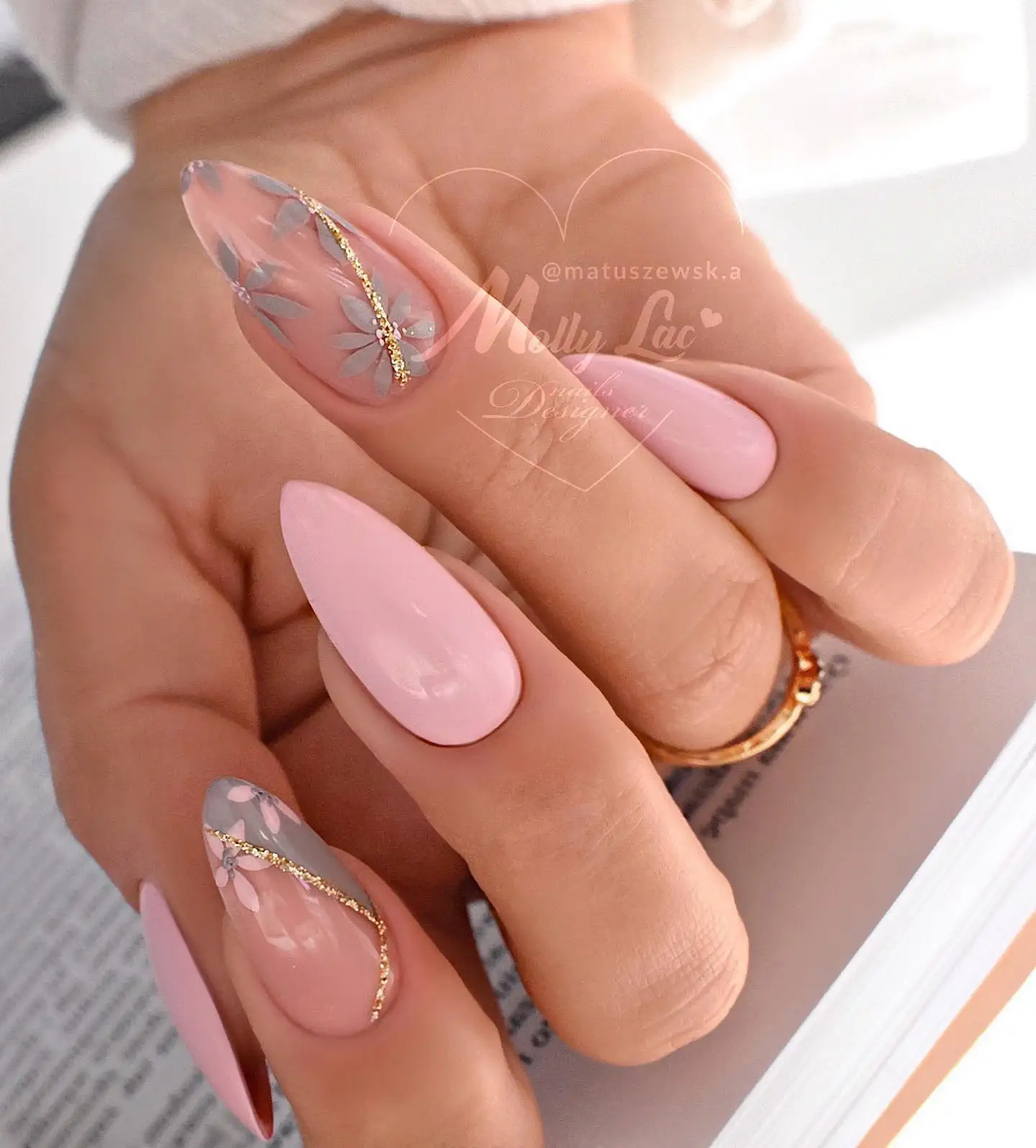 Short square nails in deep purple with white wrap detailing and large cartoonish eyes on accent nails.