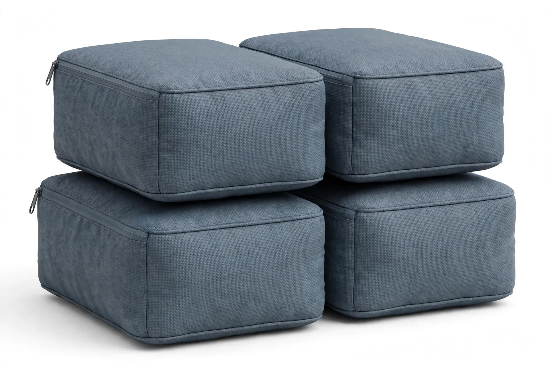 Four solid slate-blue grey rectangular packing cubes, stacked in a group, with a subtle textured patterned surface