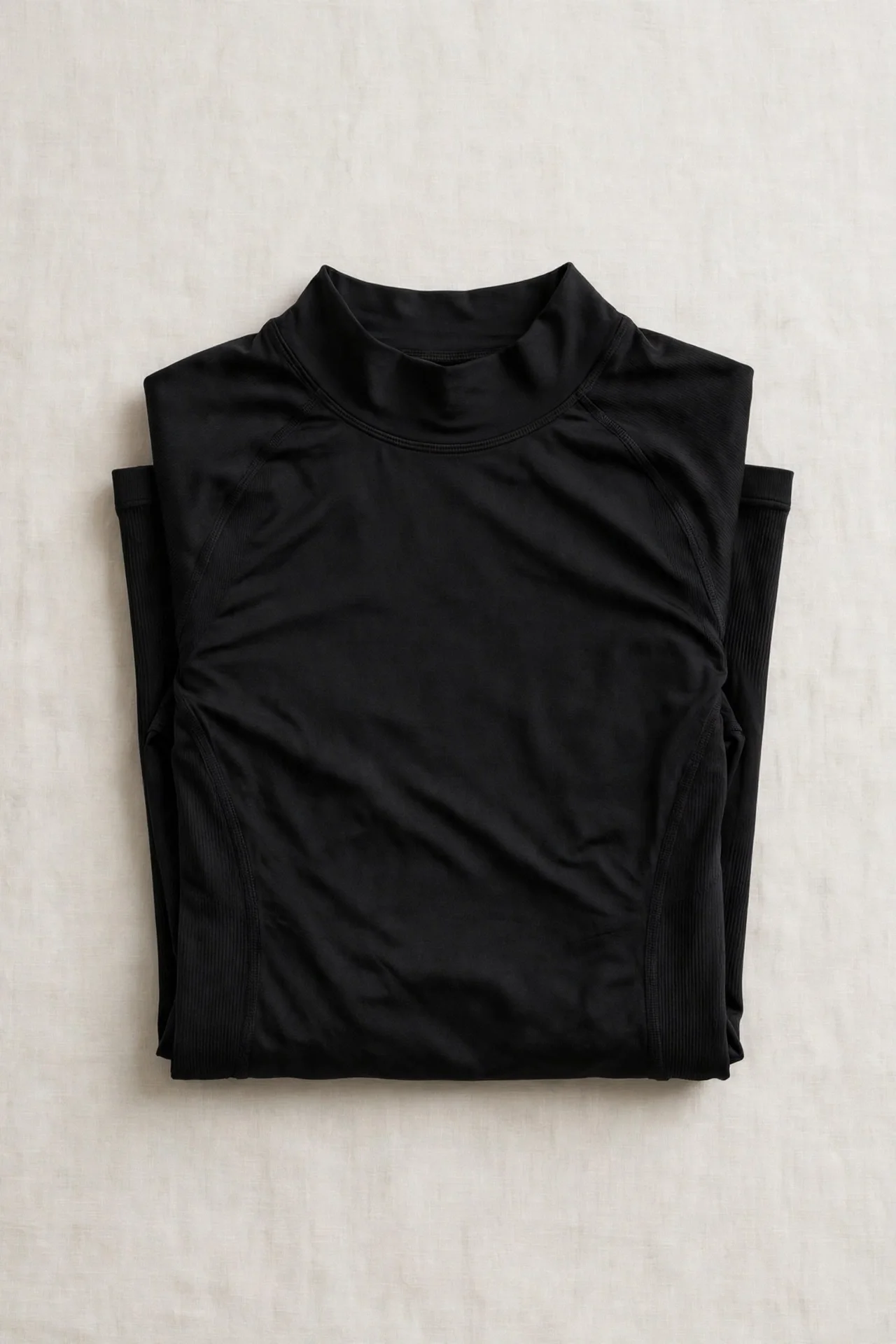 Black long-sleeve fitted top, folded