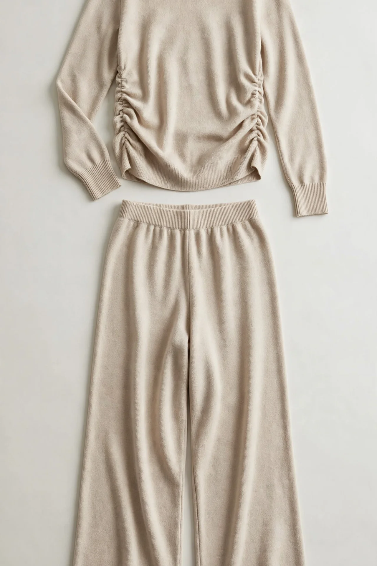 Beige two-piece lounge set with side ruching, flat lay
