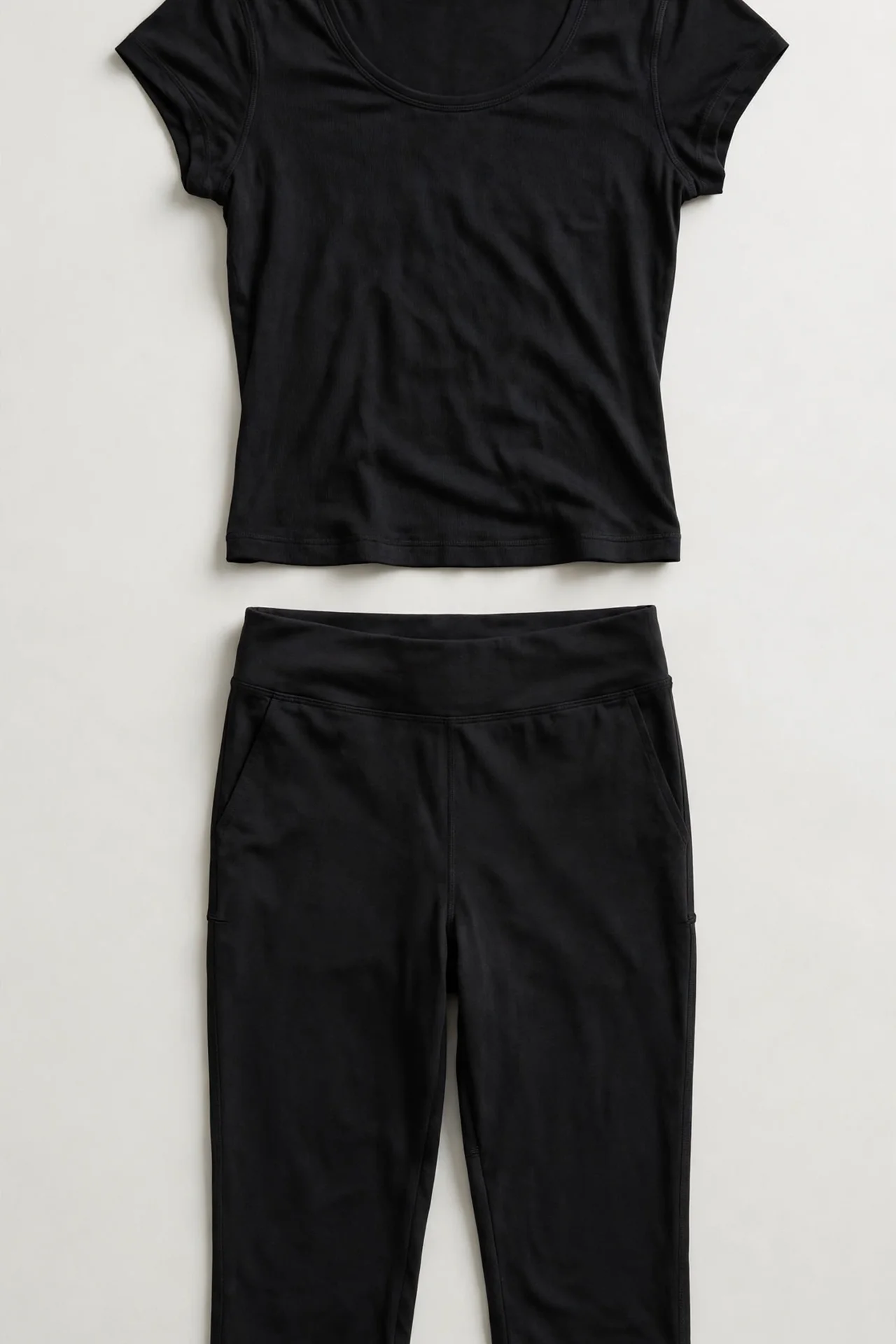 Black cap-sleeve travel set with capri pants, flat lay