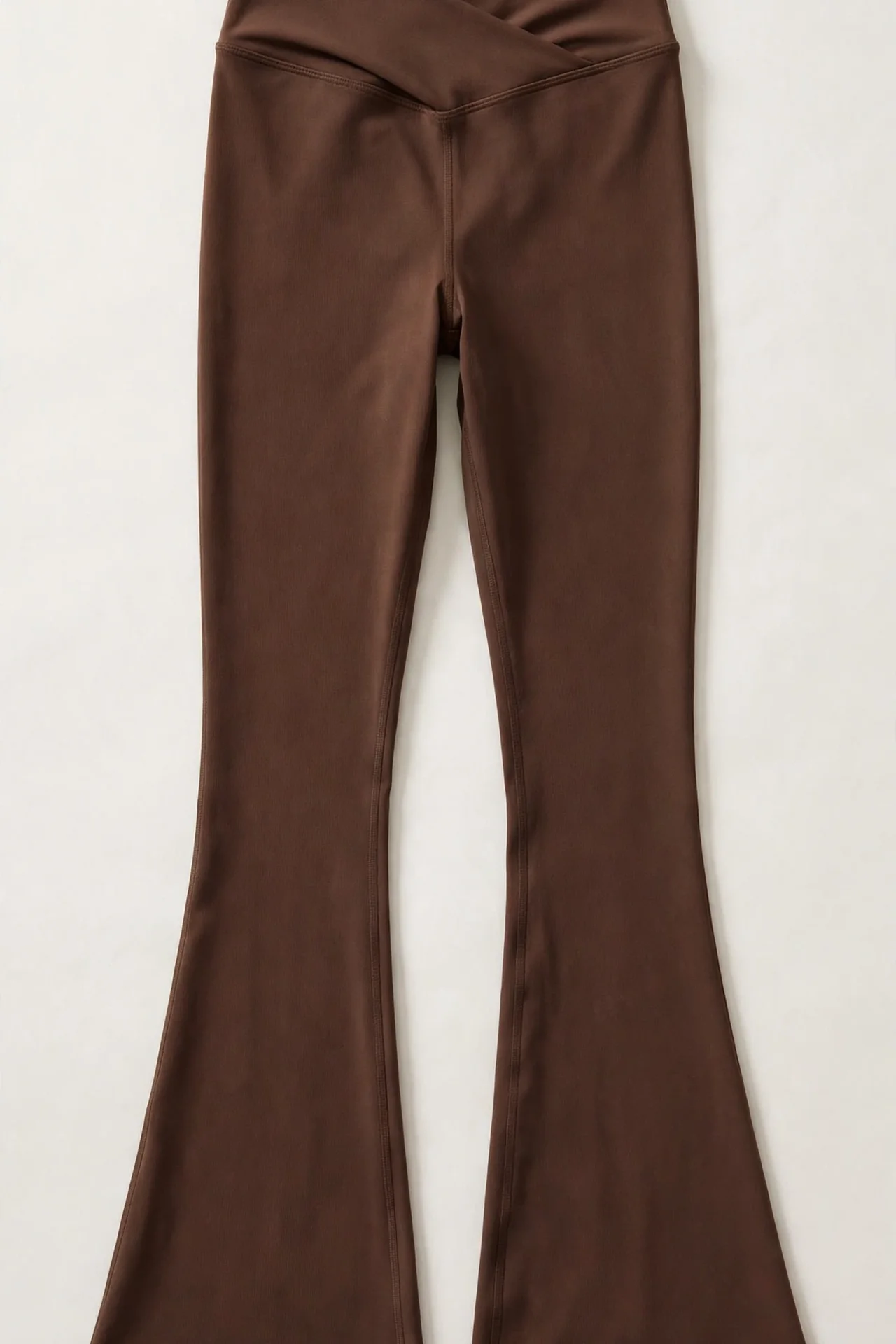Brown high-waisted crossover flare leggings, flat lay