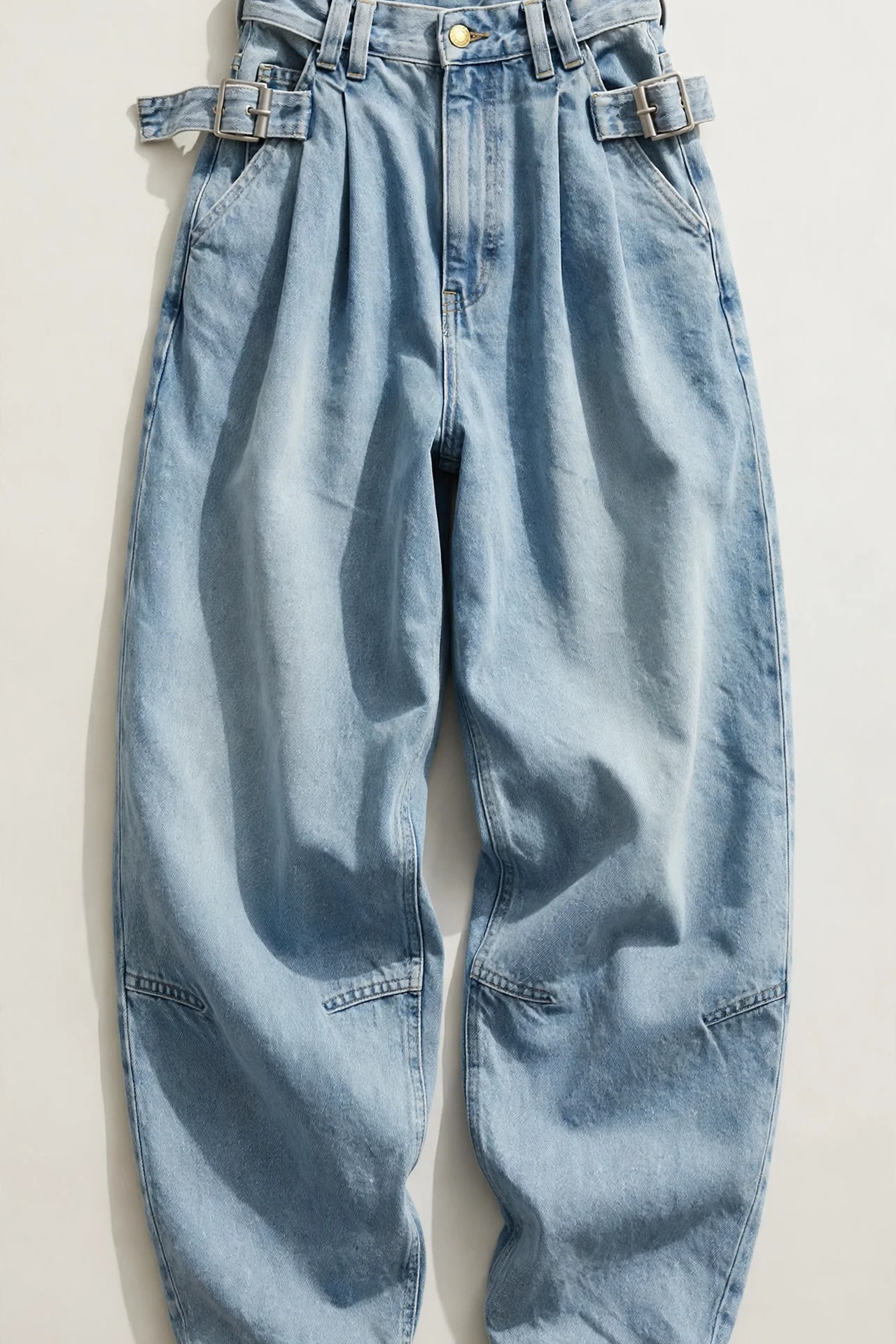 Light-wash baggy jeans with cinch waistband detail, flat lay