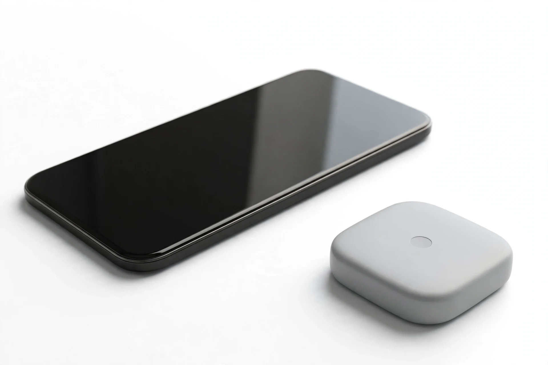 Smartphone with a blank dark screen beside a small light-grey rounded-square device