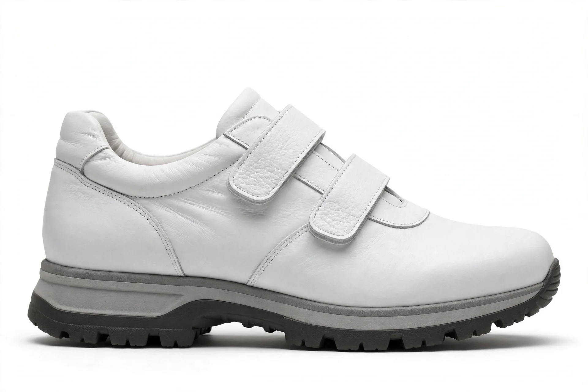 White leather walking shoe with wide velcro straps and a sturdy rubber outsole