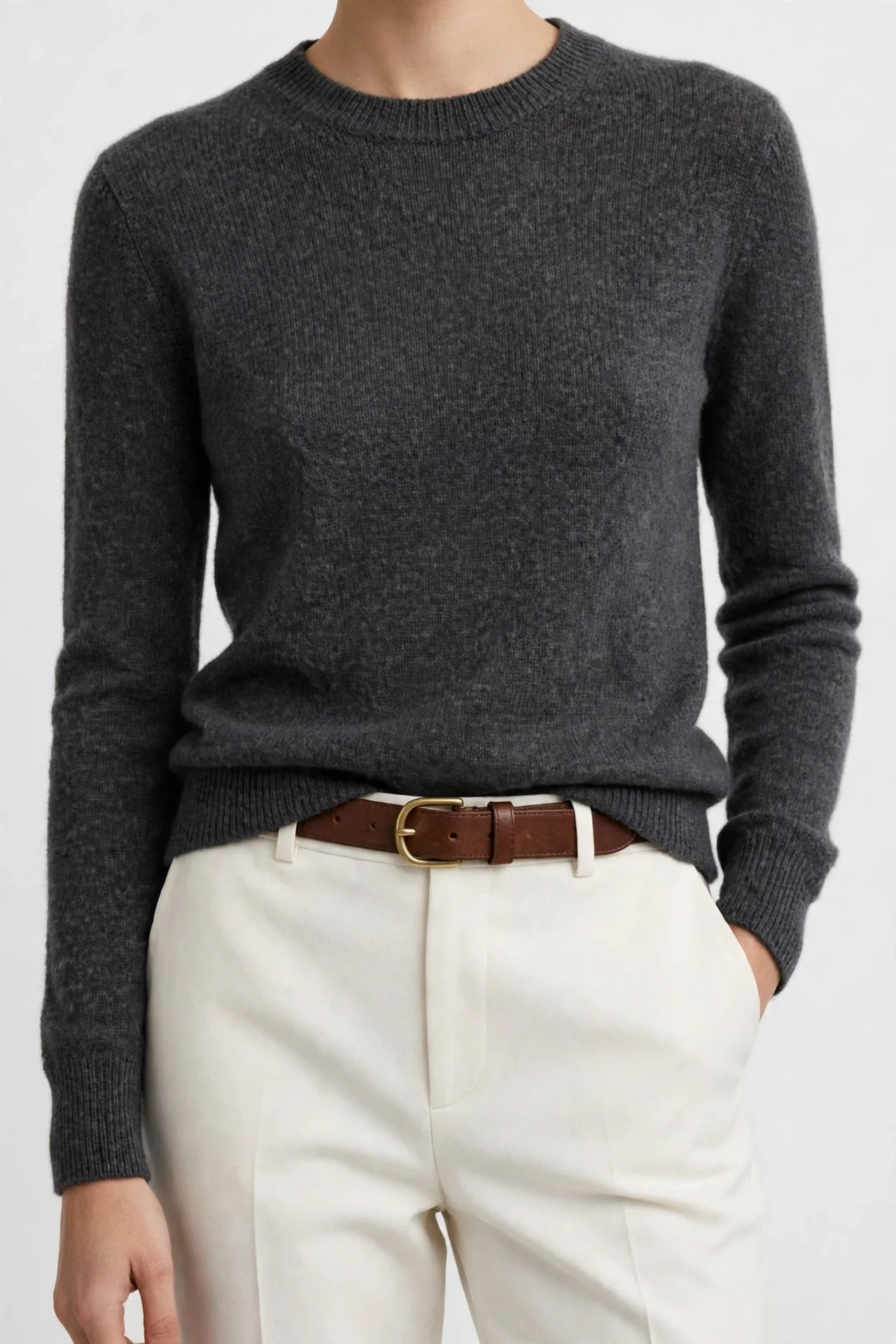 Charcoal dark-grey fine-knit crewneck sweater worn with white trousers and a brown belt