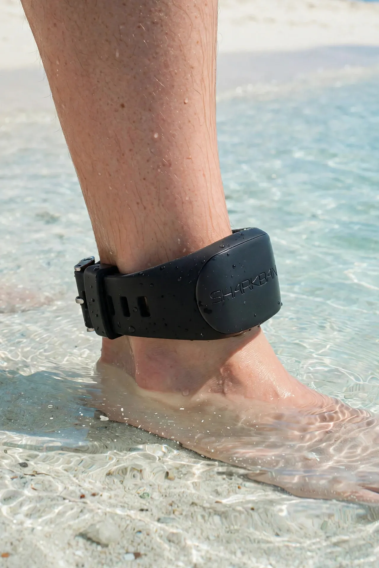 Swimmer at the beach wearing a Sharkbanz band on the ankle