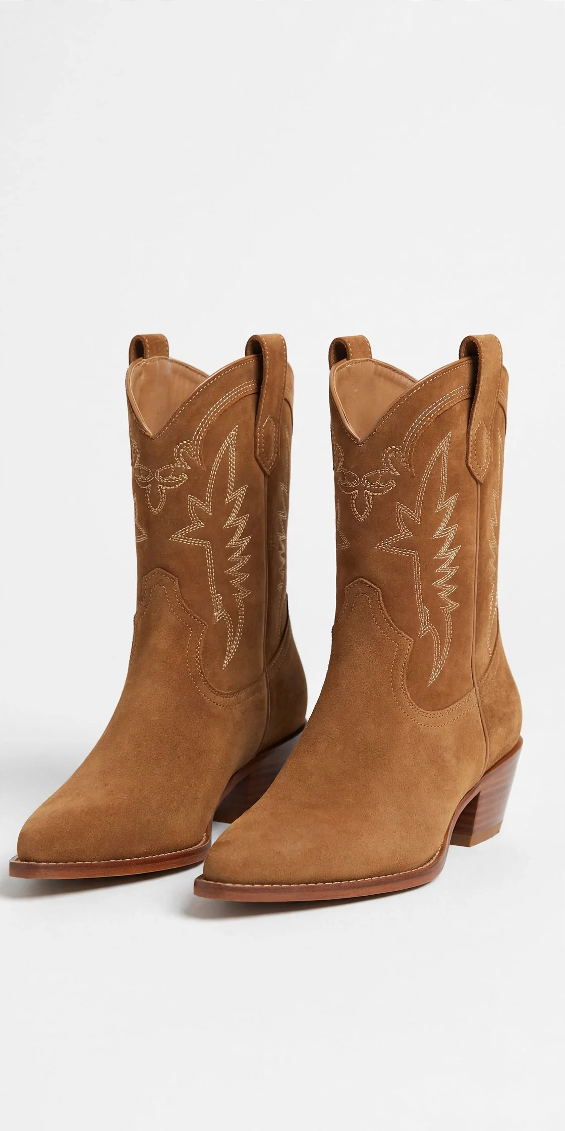 Brown women's western ankle boots with stitched shafts and pointed toes, product photo on a light background
