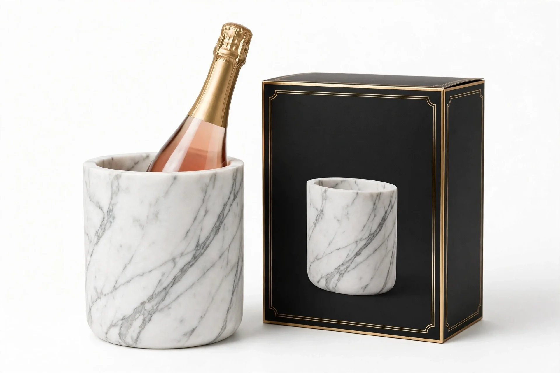 White marble bucket holding a bottle of rose champagne beside a black and gold box