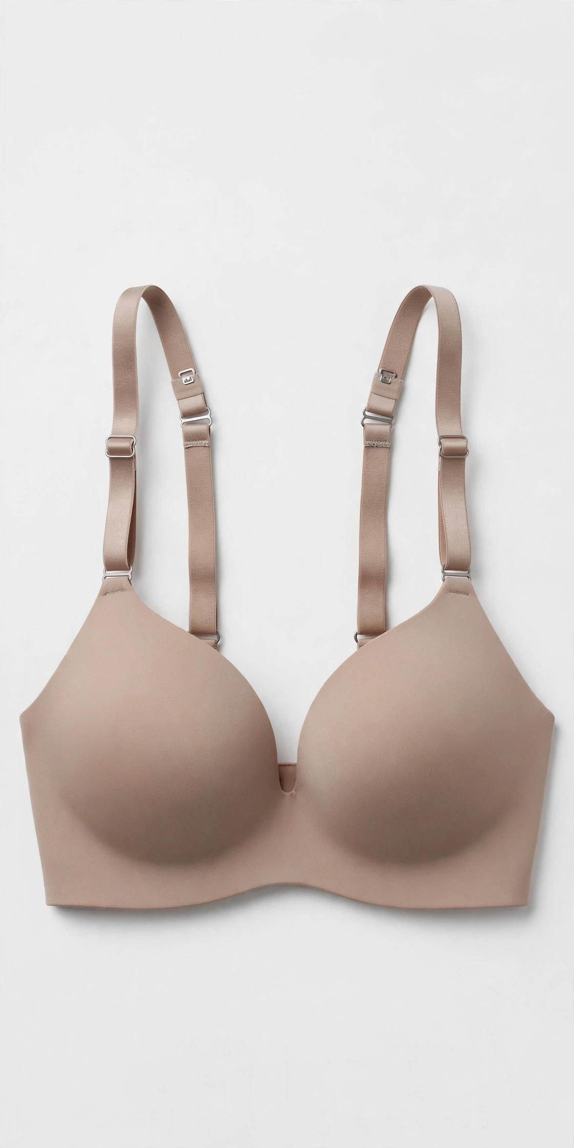 Beige women's shaping smoothing wireless bra with convertible straps, flat product photo on a light background
