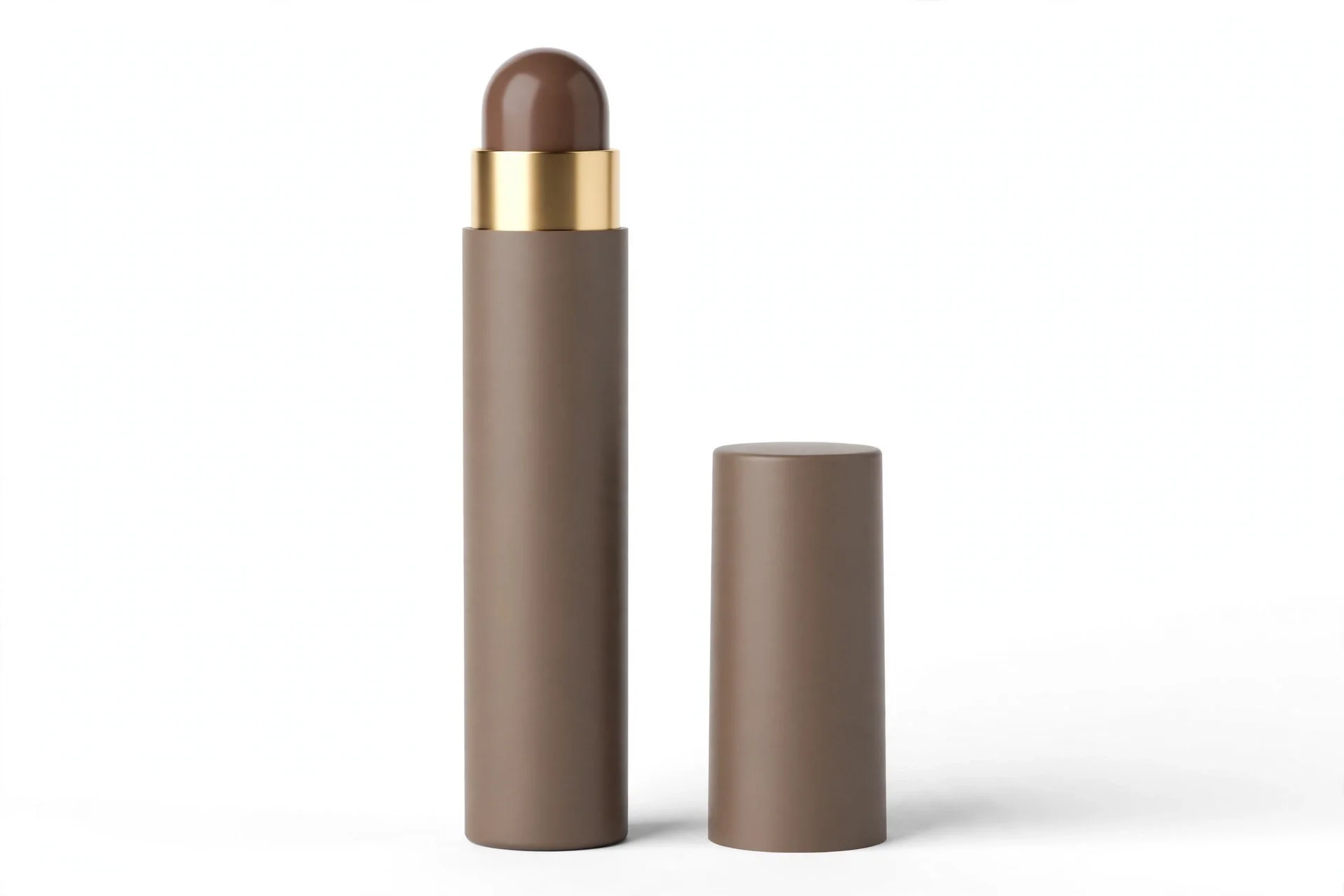 Tall matte taupe-brown stick tube with a gold collar and a rounded brown tip exposed, with its matching matte cap standing beside it