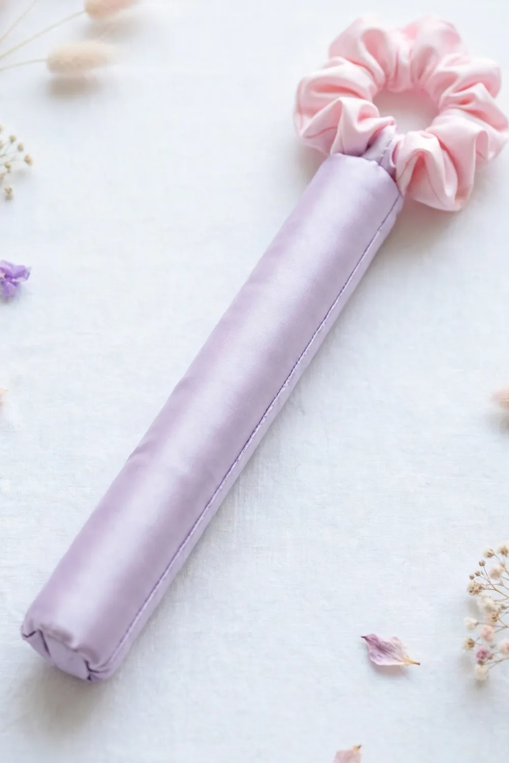 A heatless curling rod headband with a scrunchie