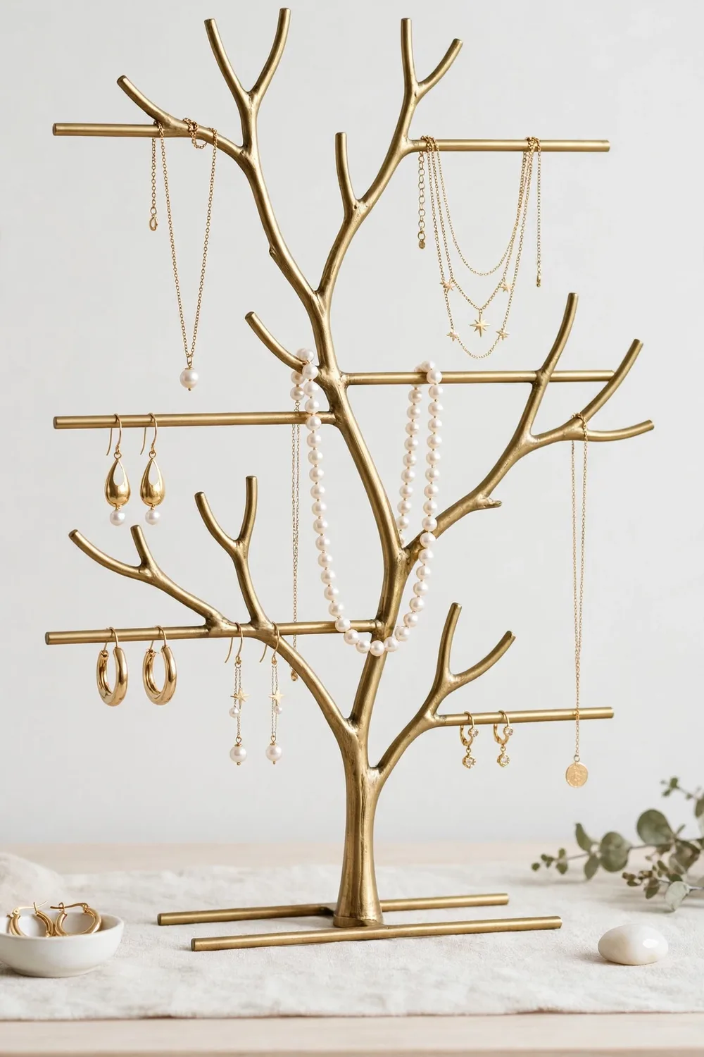 A jewelry organizer stand with necklaces and earrings
