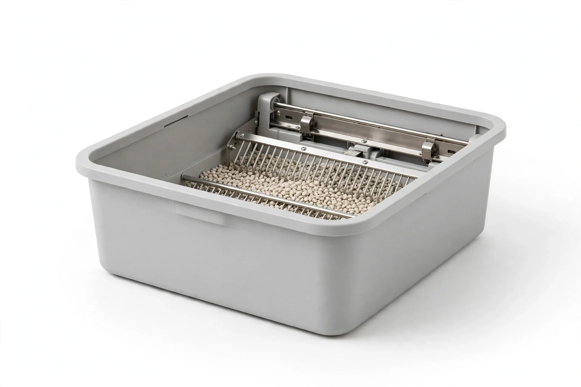 Uncovered open automatic litter box in light gray with a metal rake across the litter bed