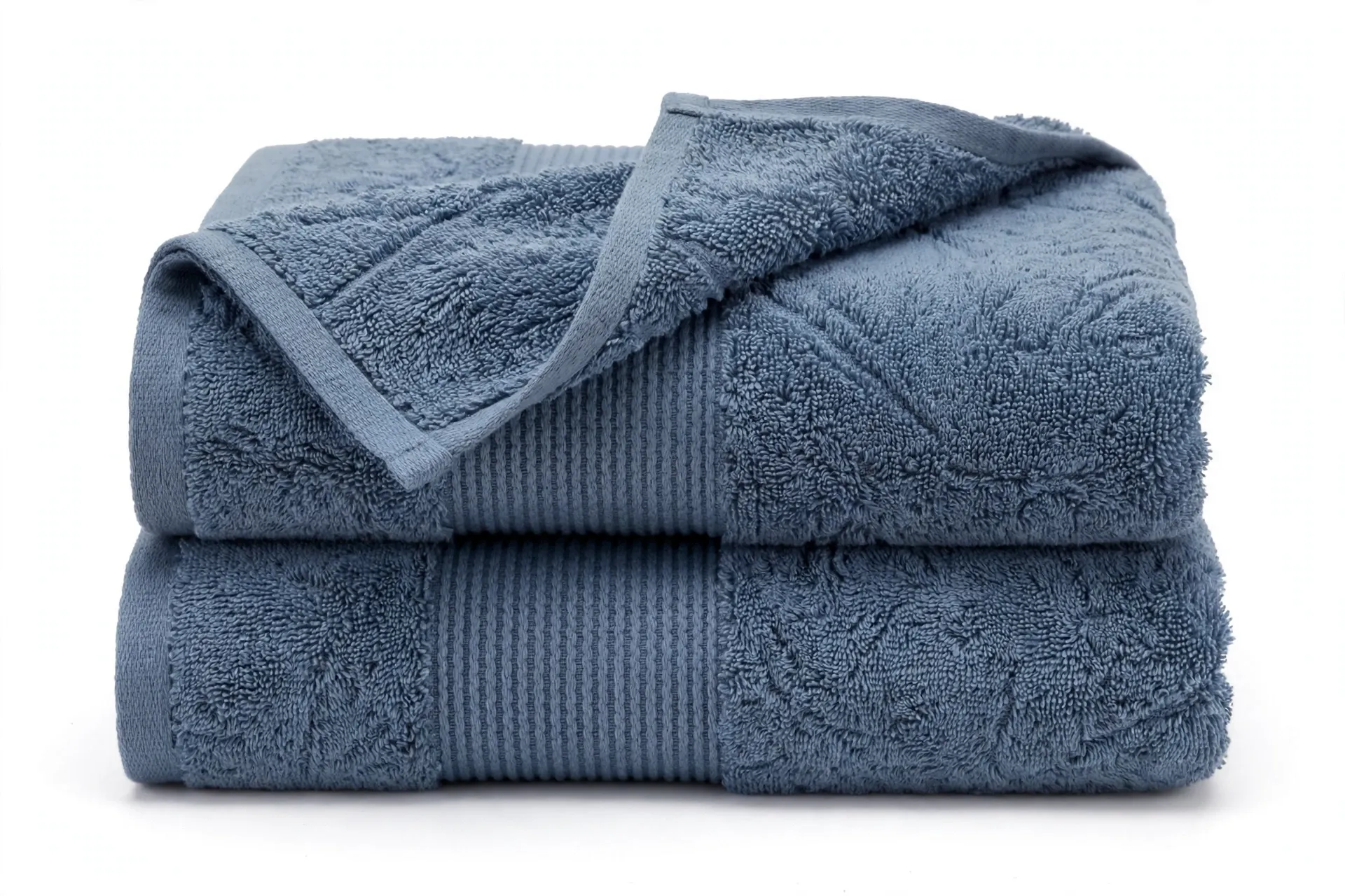 Two folded dusty slate-blue terry hand towels with a ribbed band detail
