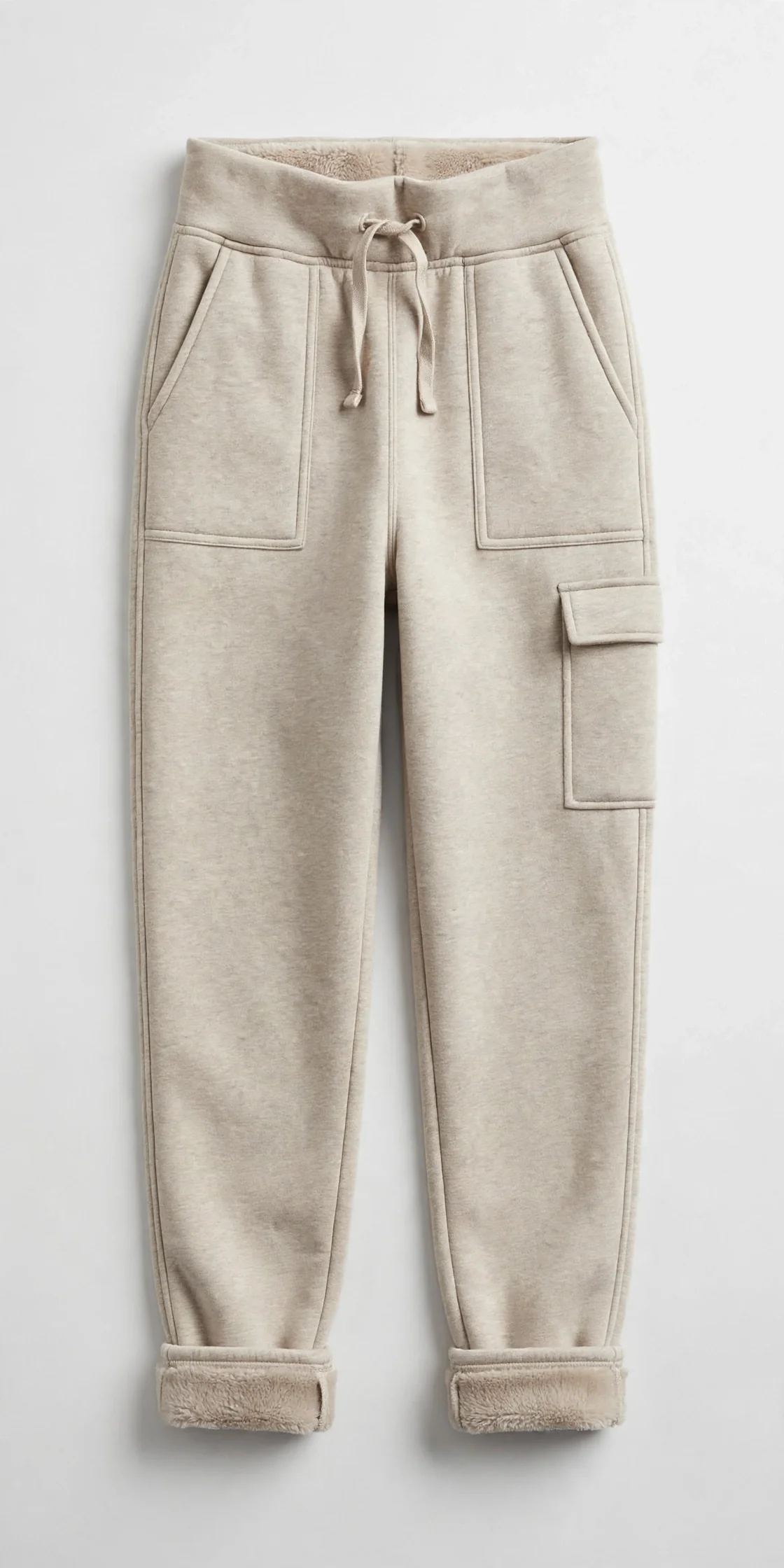 Beige women's fleece-lined high-waisted joggers with three pockets and soft cuffs, flat product photo on a light background