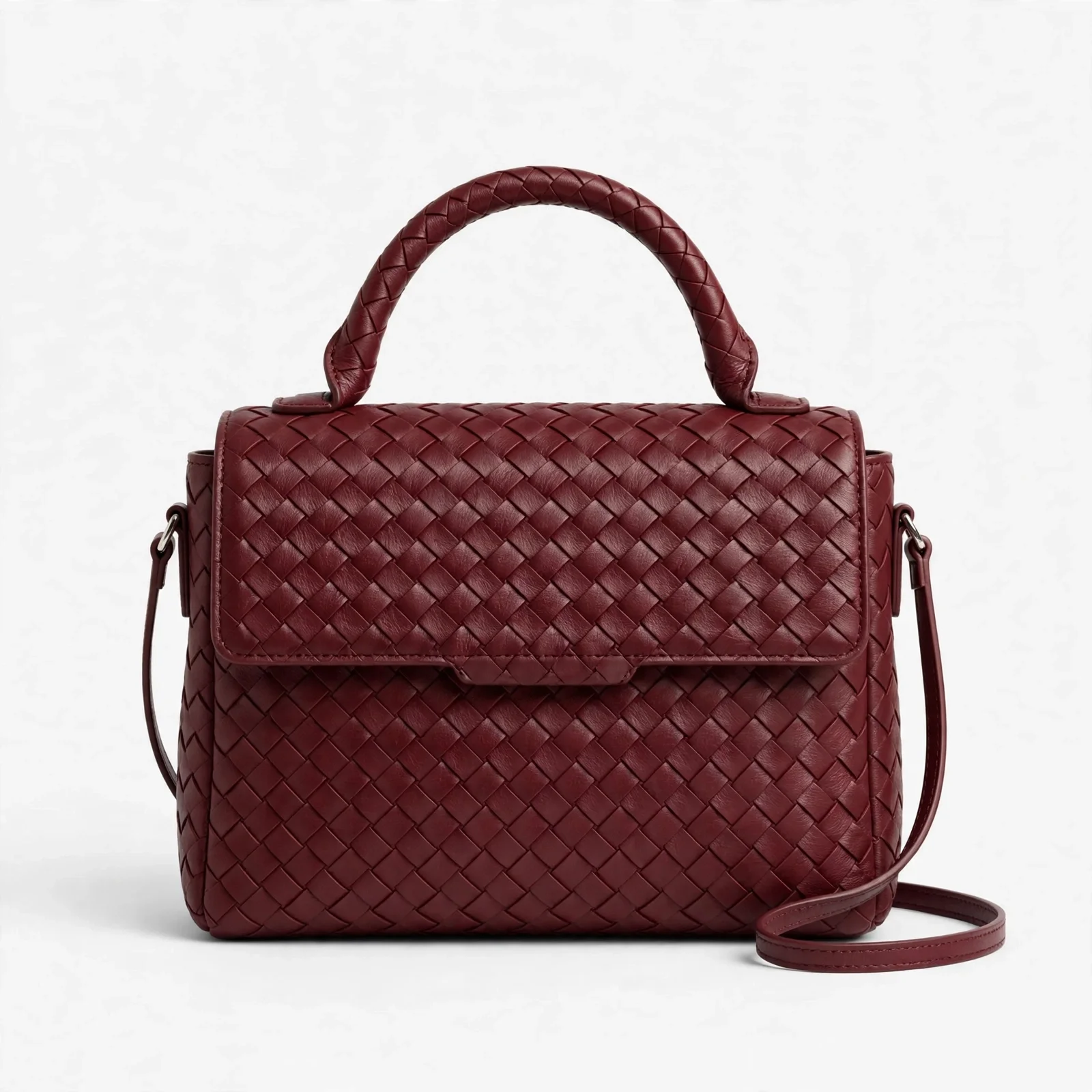 Burgundy woven satchel handbag with top handle and thin crossbody strap