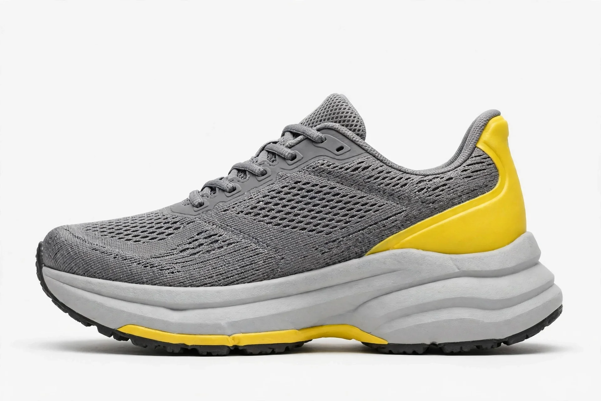 Grey running shoe with a bright yellow accent, mesh upper and thick foam midsole