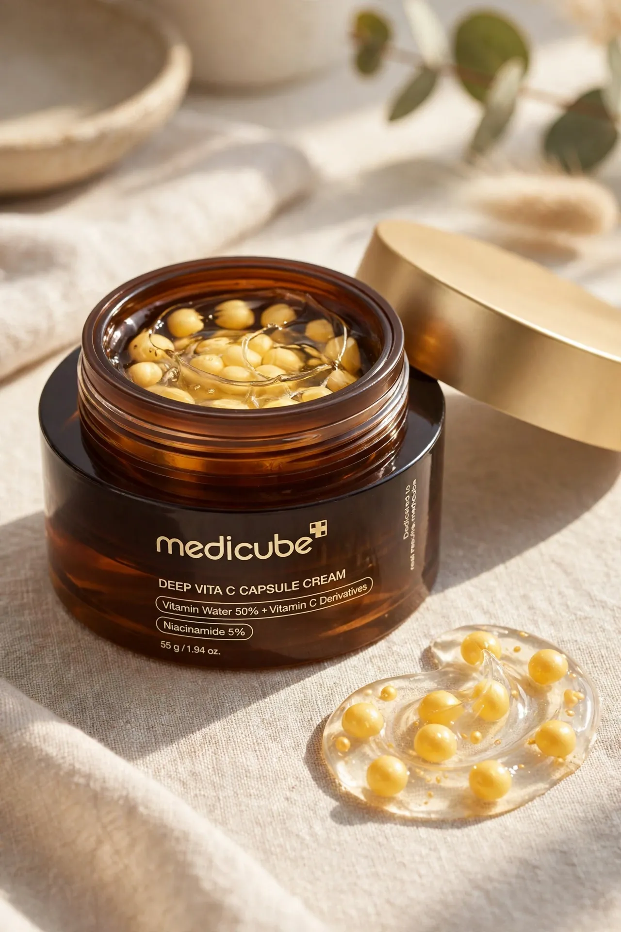 Jar of Medicube Deep Vita C capsule cream with golden capsules in gel