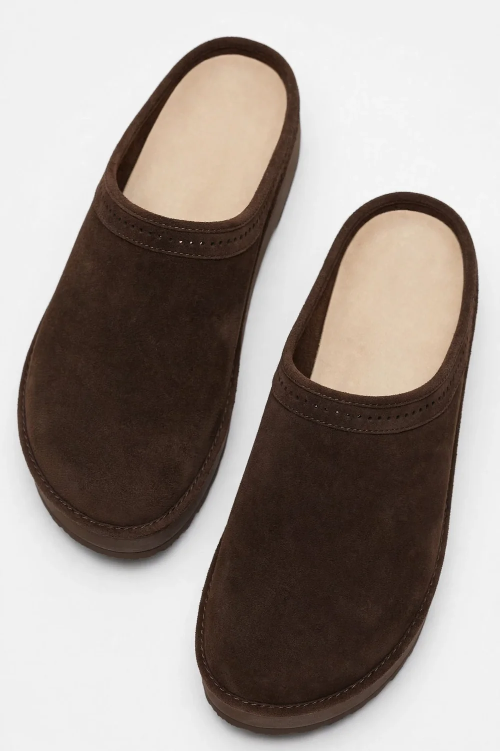 Pair of dark-brown suede closed-toe clogs on a white background, shown from above at an angle