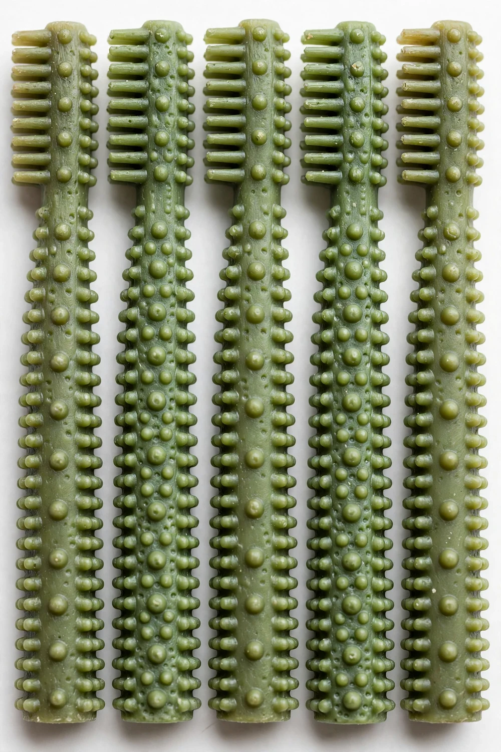 Green dental chew sticks arranged in a row