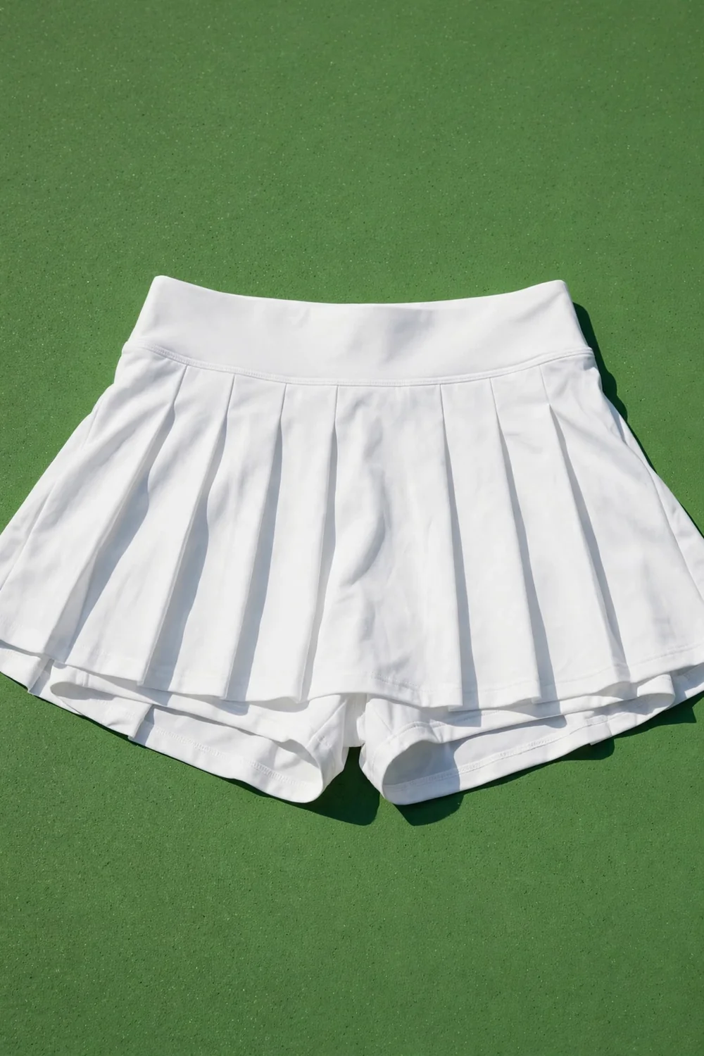A white pleated athletic skort in bright daylight